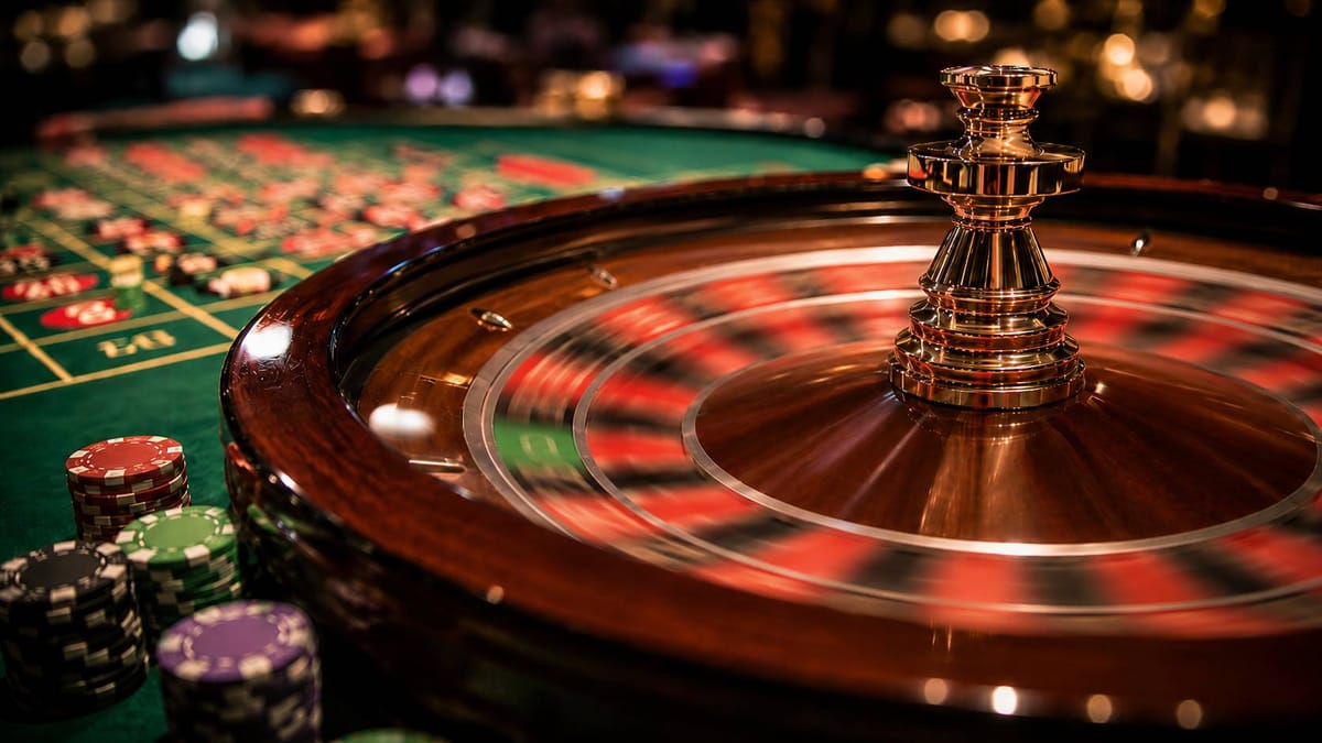 Fast-spinning European single-zero roulette wheel with a blurred green zero pocket and casino chips on the table.