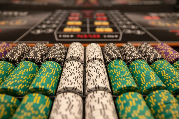 Close-up of premium stacked casino chips on a table layout illustrating maximum UK online casino withdrawal limits.